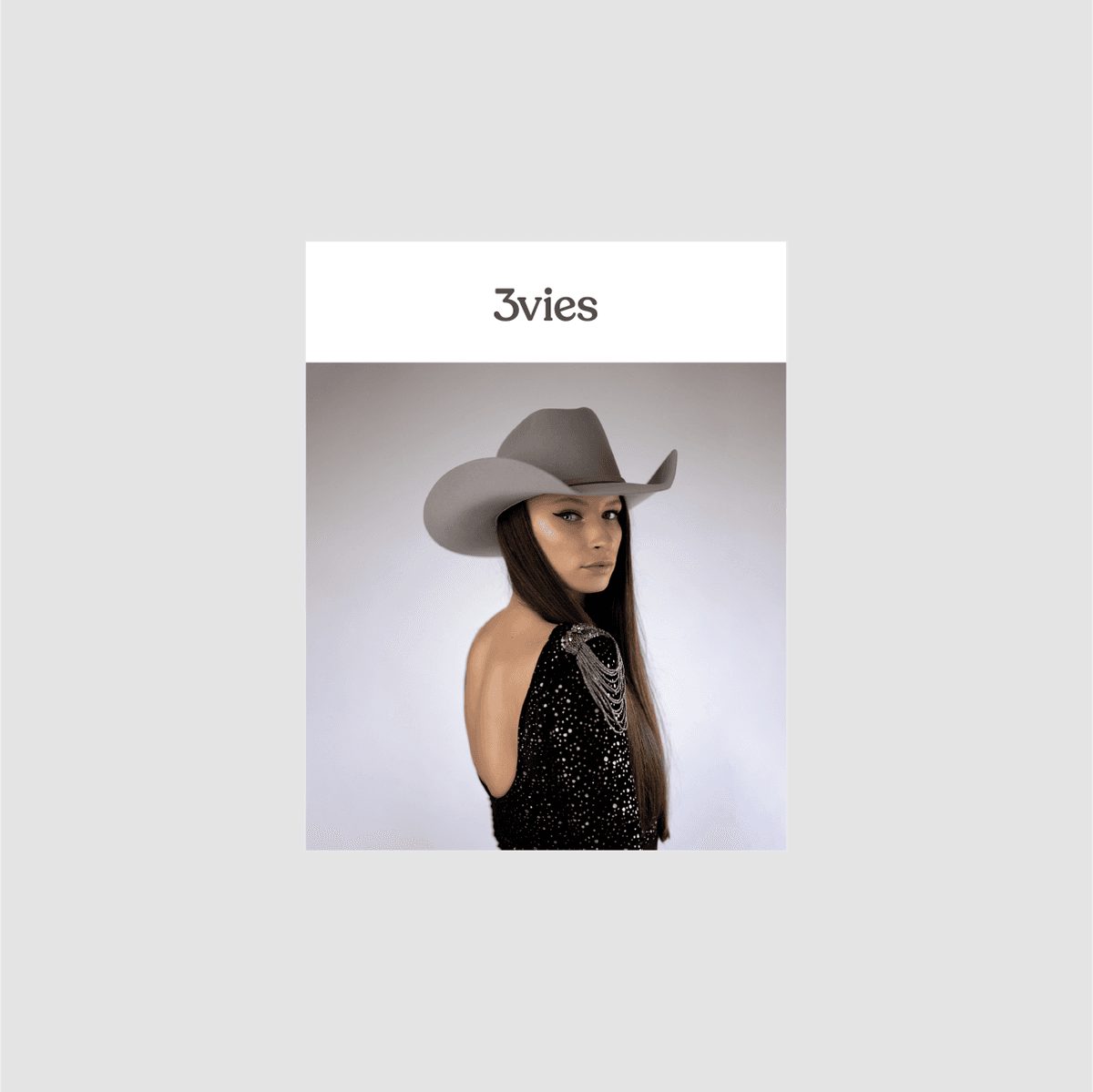 Cover of 3vies Volume 36, a woman in a gray cowboy hat and sequined backless top.