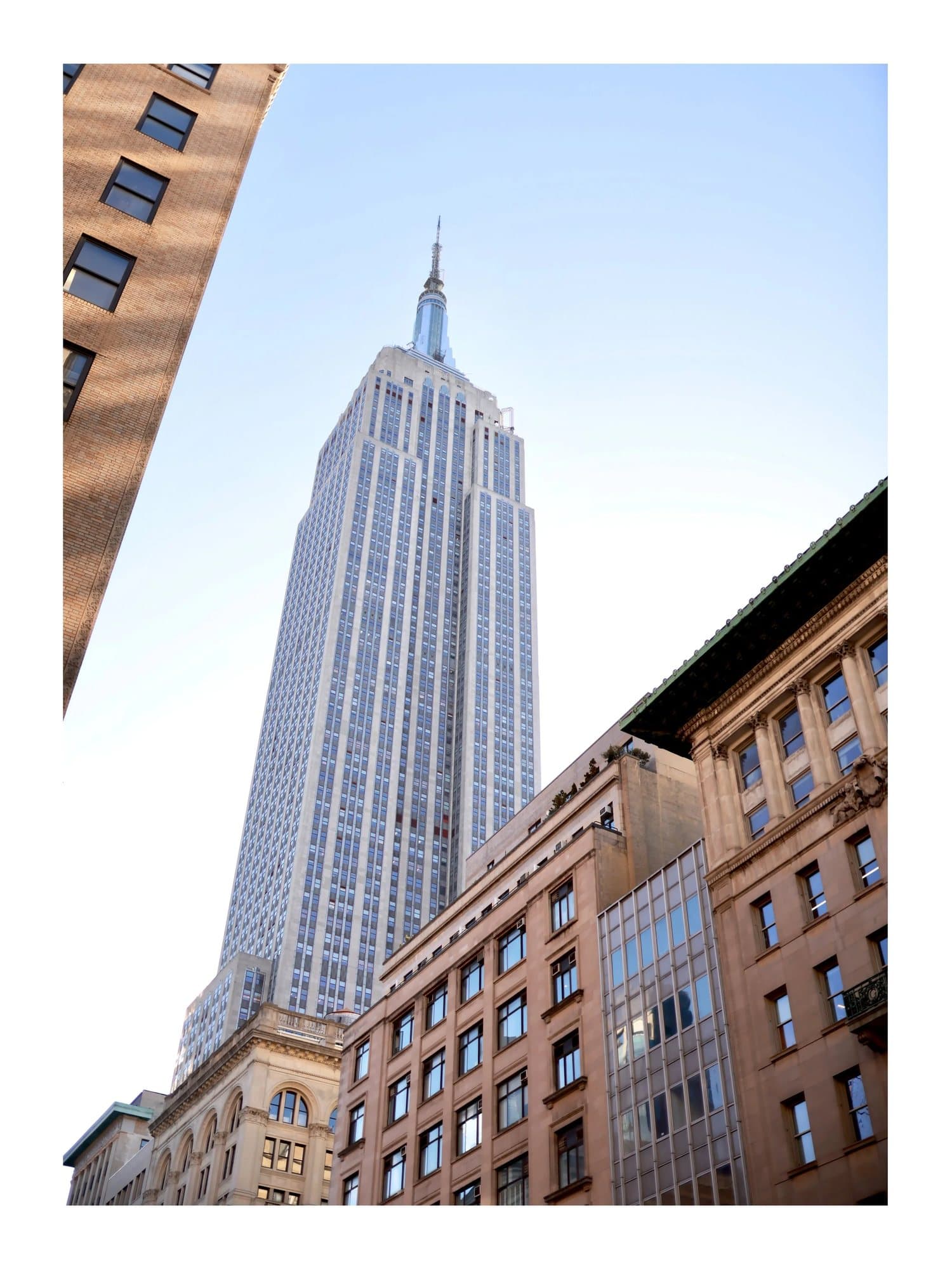 The Empire State Building rising above Manhattan storefronts, TIMELESS print NYC.