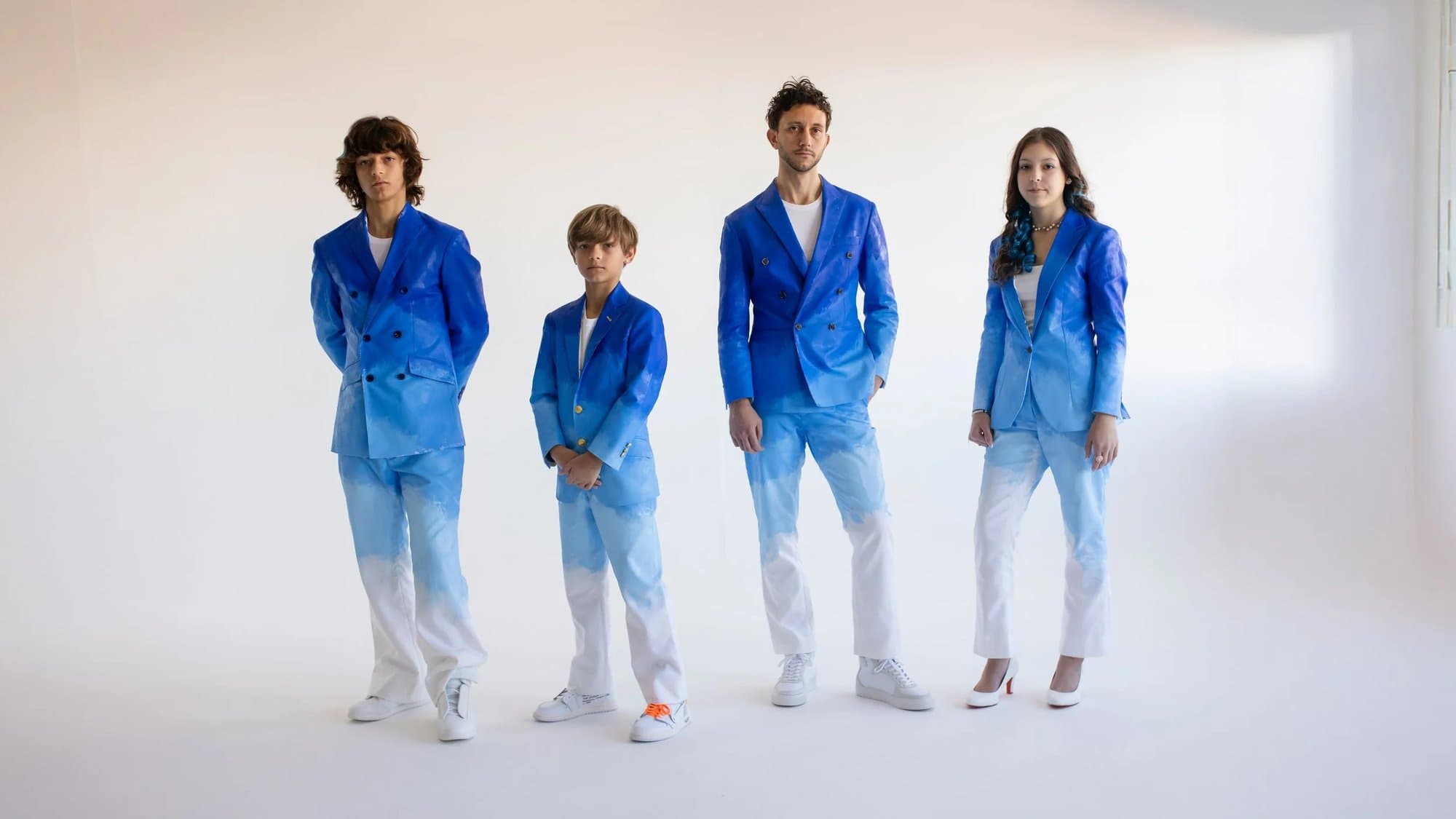 Mark and his three children in the custom hand-painted blue suits made with Limatus Bespoke for the exhibit.